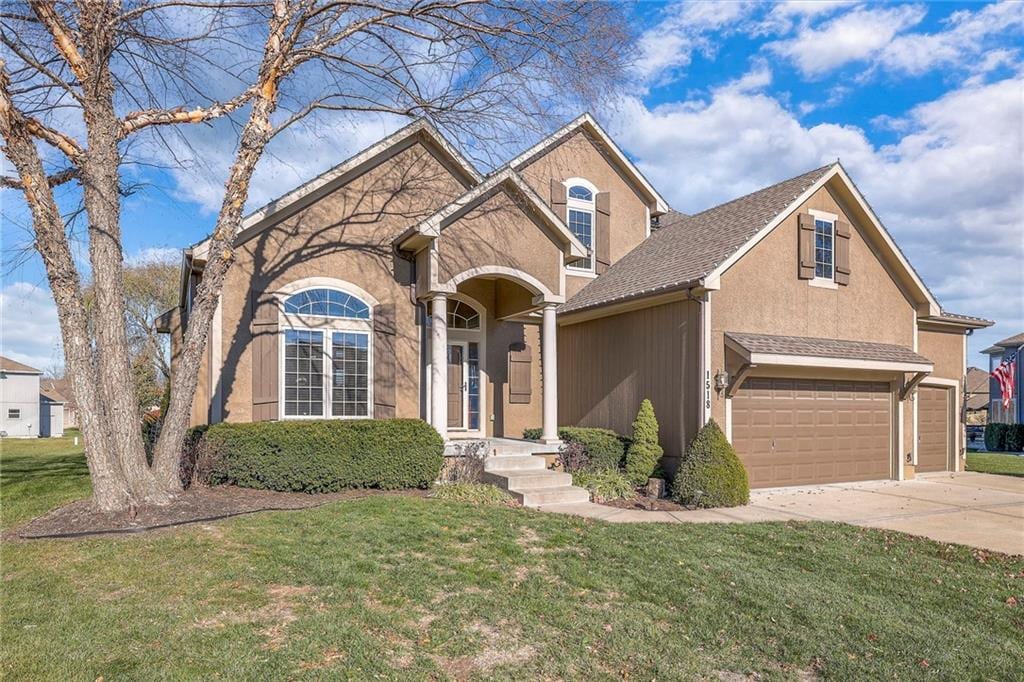 front of property with a front lawn and a garage