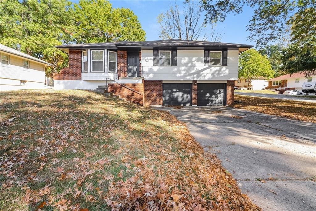 3619 S Haden Dr, Independence, MO 64055 - view of front facade with a garage and a front lawn