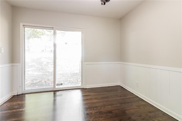 spare room featuring dark hardwood / wood-style floors