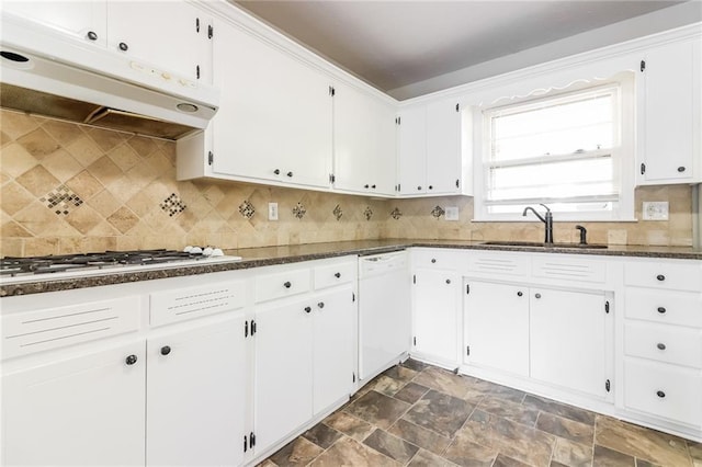 kitchen with white cabinets, white appliances, dark stone countertops, and sink