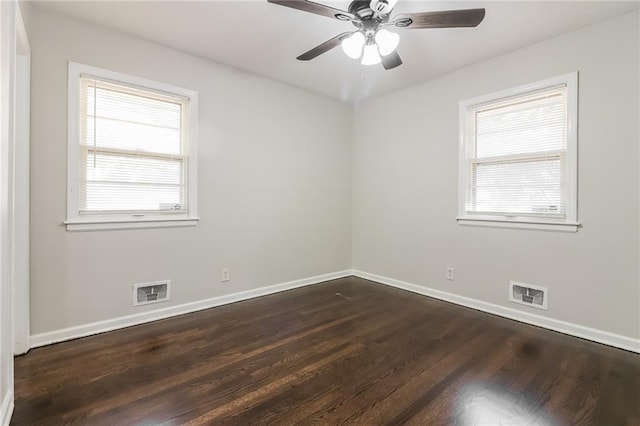 empty room with ceiling fan and dark hardwood / wood-style floors