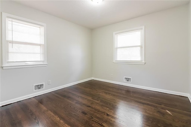 unfurnished room featuring dark wood-type flooring