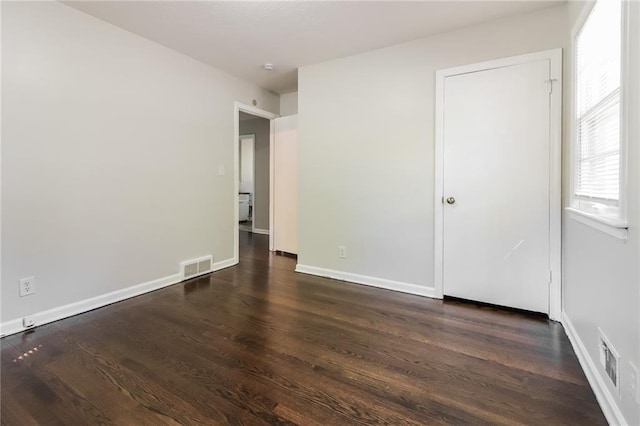 empty room featuring dark hardwood / wood-style flooring