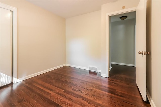 spare room with dark hardwood / wood-style floors