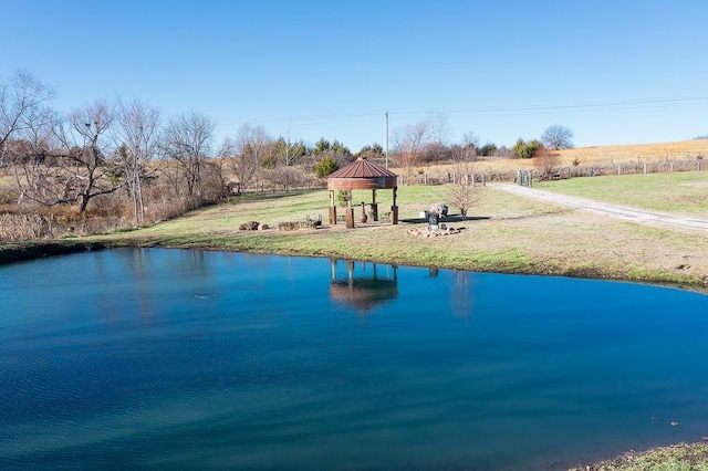 view of pool featuring a gazebo, a water view, and a lawn