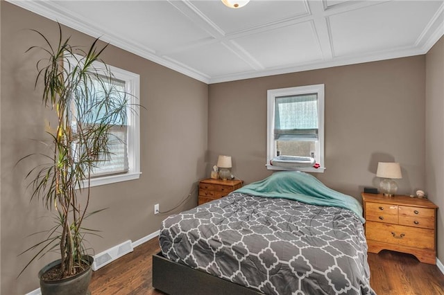 bedroom featuring dark hardwood / wood-style floors, ornamental molding, and coffered ceiling