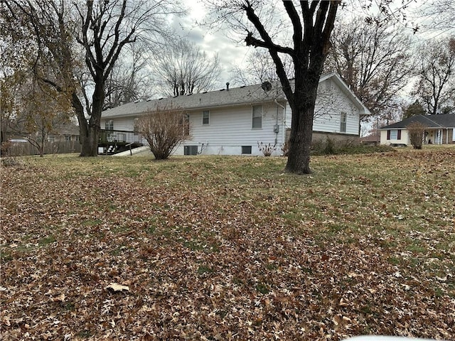 rear view of house featuring a yard and central air condition unit