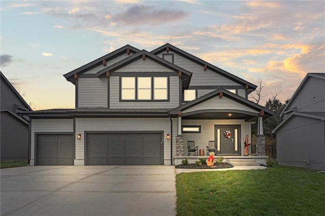 view of front of property featuring a lawn and a garage