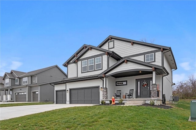 craftsman house featuring central AC, a porch, a garage, and a front lawn