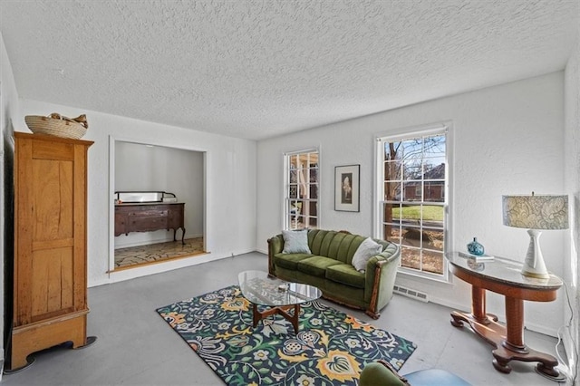 living room with finished concrete flooring and a textured ceiling