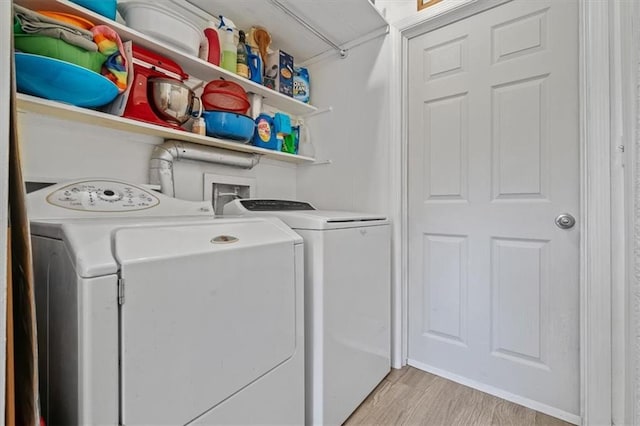 laundry area featuring laundry area, washer and clothes dryer, and light wood finished floors