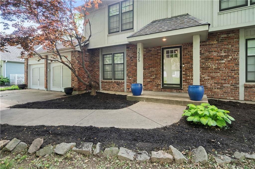 doorway to property with a garage