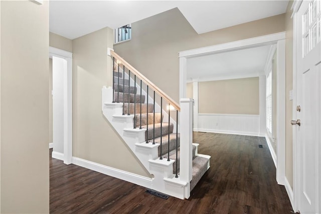 staircase featuring wood-type flooring