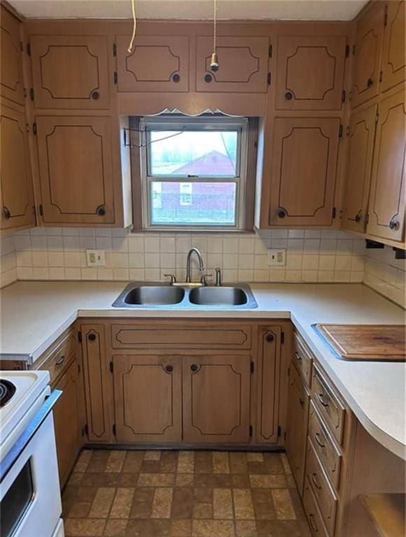 kitchen with tasteful backsplash, sink, and white range with electric stovetop