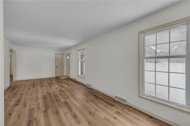 unfurnished room with light hardwood / wood-style floors