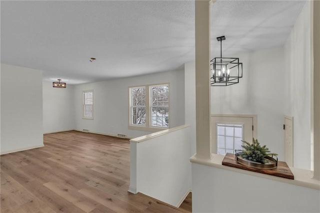 interior space featuring light hardwood / wood-style flooring and an inviting chandelier