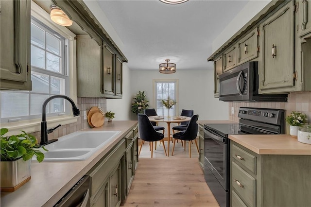 kitchen with tasteful backsplash, sink, light wood-type flooring, and black range with electric cooktop