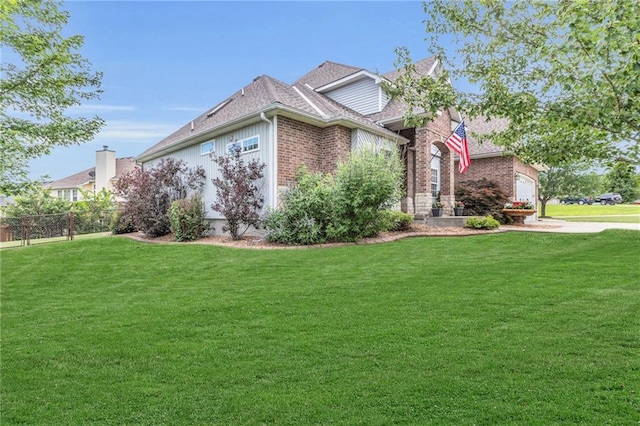 view of front of home featuring a front yard and a garage