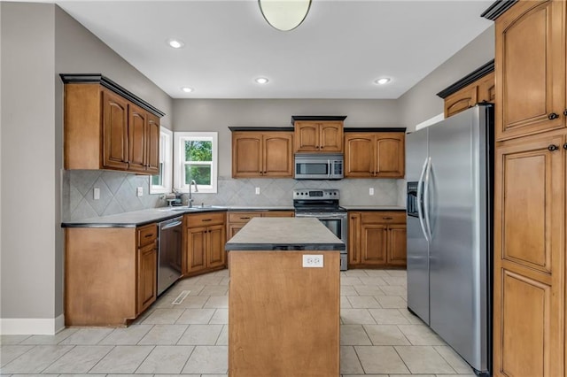 kitchen with a center island, backsplash, sink, light tile patterned flooring, and stainless steel appliances