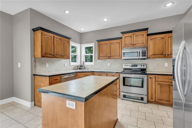 kitchen with tasteful backsplash, a center island, stainless steel appliances, and sink