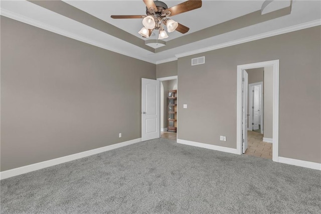 unfurnished bedroom featuring ceiling fan, crown molding, and light colored carpet