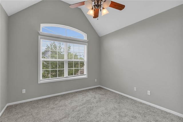 carpeted empty room with ceiling fan and lofted ceiling