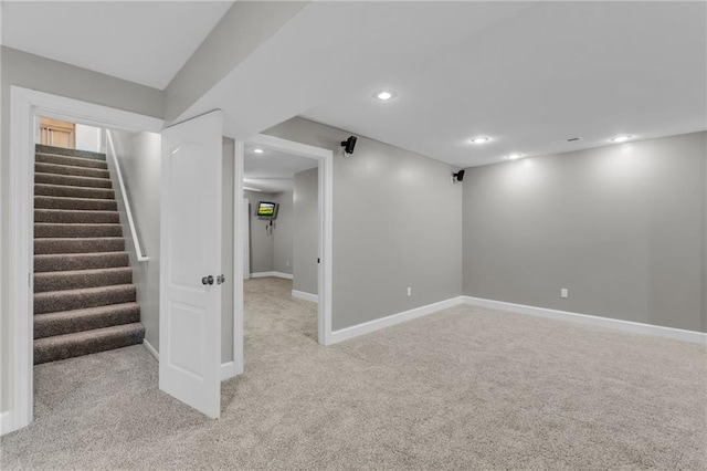 basement featuring light colored carpet