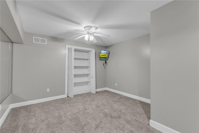 unfurnished bedroom featuring ceiling fan and light carpet