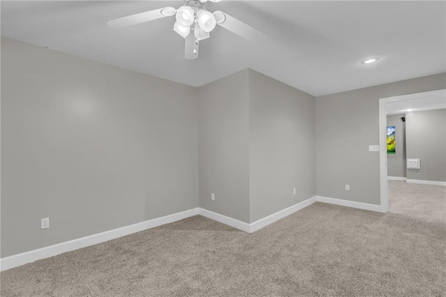 carpeted empty room featuring ceiling fan