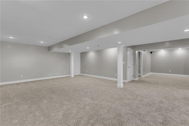 basement featuring light carpet