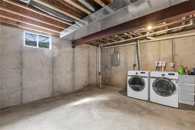 basement featuring electric panel and washer and clothes dryer