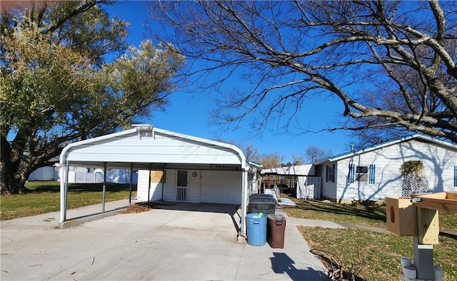 view of front of property with a carport and a front lawn