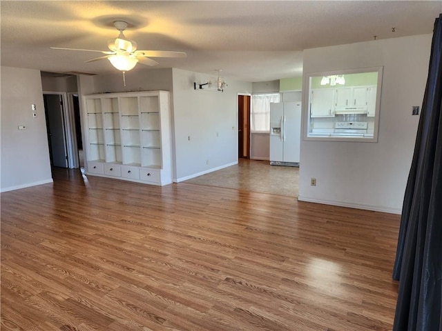 interior space with ceiling fan and wood-type flooring