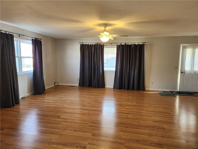 spare room with ceiling fan, hardwood / wood-style floors, and a textured ceiling