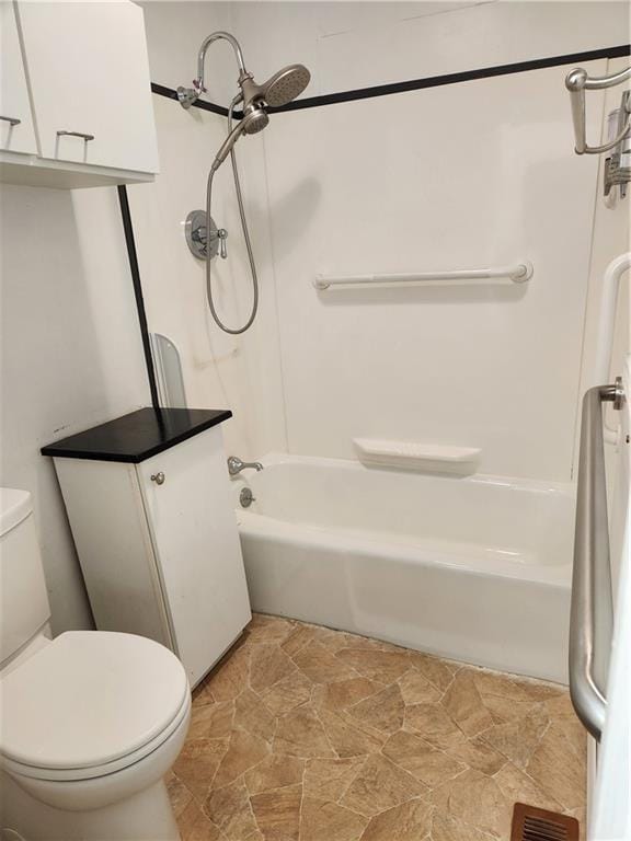 bathroom featuring bathing tub / shower combination and toilet