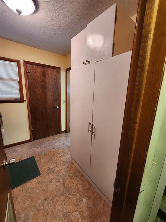 hallway featuring a textured ceiling