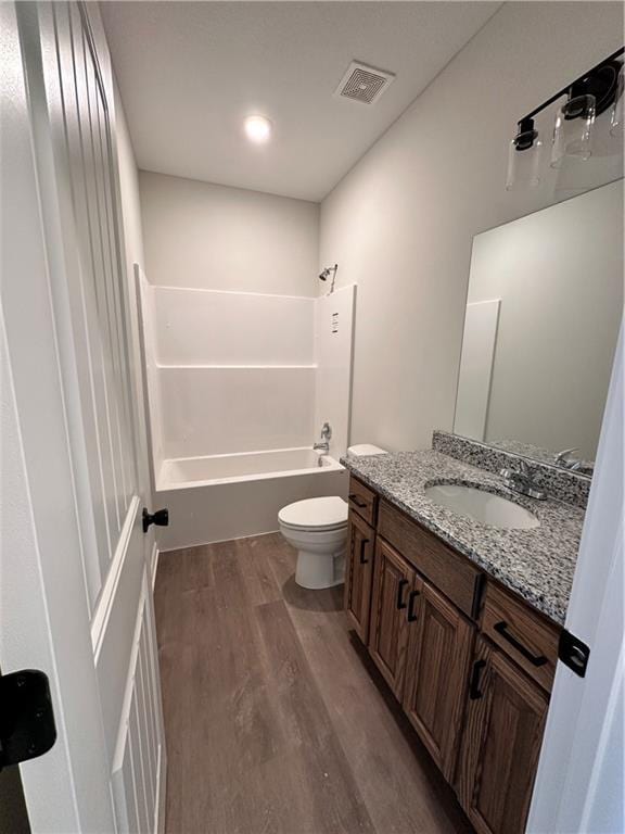 full bathroom with toilet, vanity, shower / bath combination, and hardwood / wood-style flooring