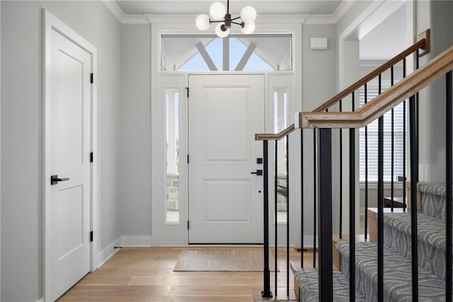 1516 NW 106th St, Kansas City, MO 64155 - foyer entrance featuring stairs, ornamental molding, a chandelier, and light wood-type flooring