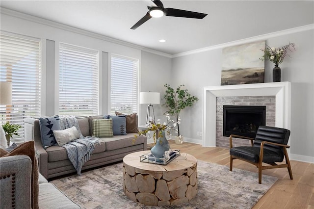 1516 NW 106th St, Kansas City, MO 64155 - living area featuring a ceiling fan, ornamental molding, light wood-type flooring, baseboards, and a brick fireplace