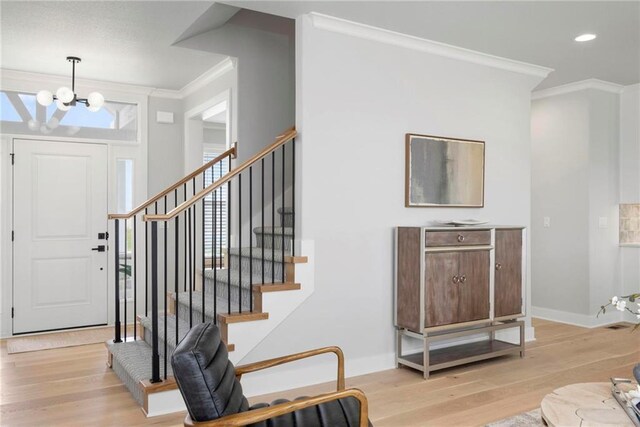 1516 NW 106th St, Kansas City, MO 64155 - foyer entrance featuring a chandelier, stairway, wood finished floors, and ornamental molding