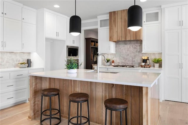 1516 NW 106th St, Kansas City, MO 64155 - kitchen with white cabinets, tasteful backsplash, light wood-type flooring, and a sink