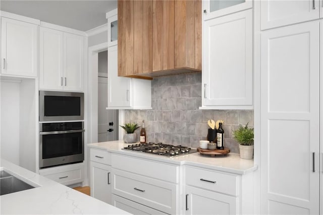 1516 NW 106th St, Kansas City, MO 64155 - kitchen with white cabinets, stainless steel appliances, glass insert cabinets, light stone countertops, and tasteful backsplash