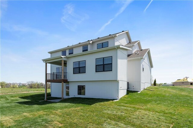1516 NW 106th St, Kansas City, MO 64155 - back of house with a balcony and a yard
