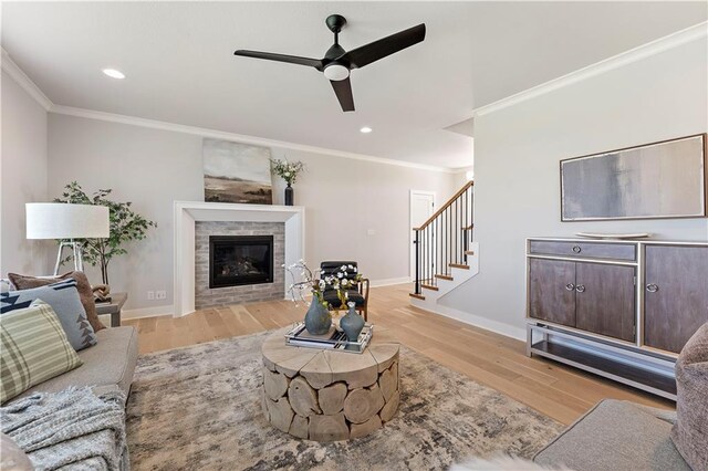 1516 NW 106th St, Kansas City, MO 64155 - living area with a glass covered fireplace, light wood-style floors, ceiling fan, and crown molding
