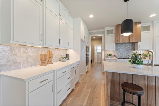 1516 NW 106th St, Kansas City, MO 64155 - kitchen with a sink, light wood-type flooring, light countertops, white cabinetry, and recessed lighting