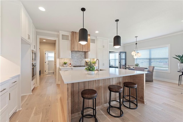 1516 NW 106th St, Kansas City, MO 64155 - kitchen with a sink, light wood-type flooring, baseboards, glass insert cabinets, and appliances with stainless steel finishes