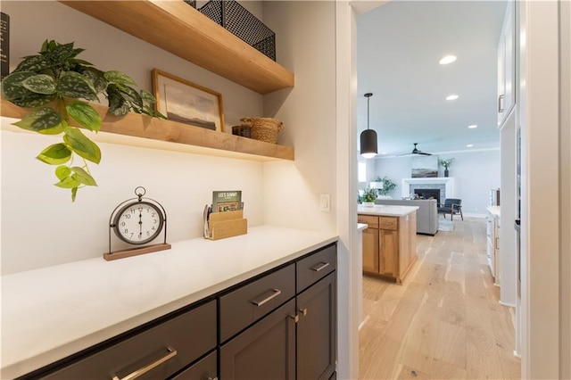 1516 NW 106th St, Kansas City, MO 64155 - bar featuring recessed lighting, light wood-type flooring, decorative light fixtures, a fireplace, and ceiling fan