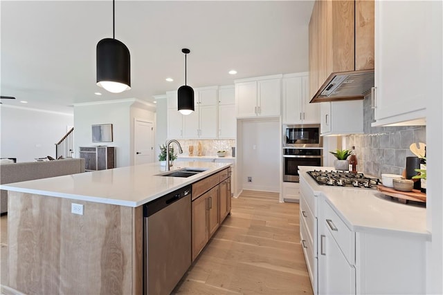 1516 NW 106th St, Kansas City, MO 64155 - kitchen featuring a sink, light wood-type flooring, backsplash, light countertops, and appliances with stainless steel finishes