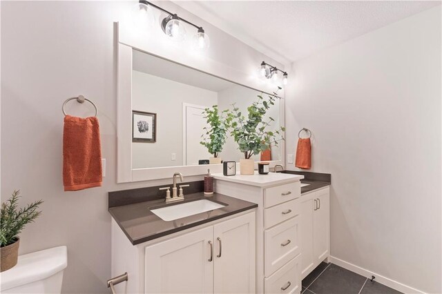1516 NW 106th St, Kansas City, MO 64155 - bathroom featuring double vanity, tile patterned floors, toilet, and a sink