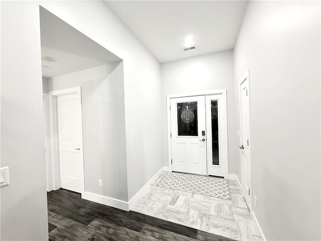 foyer entrance with dark wood-type flooring